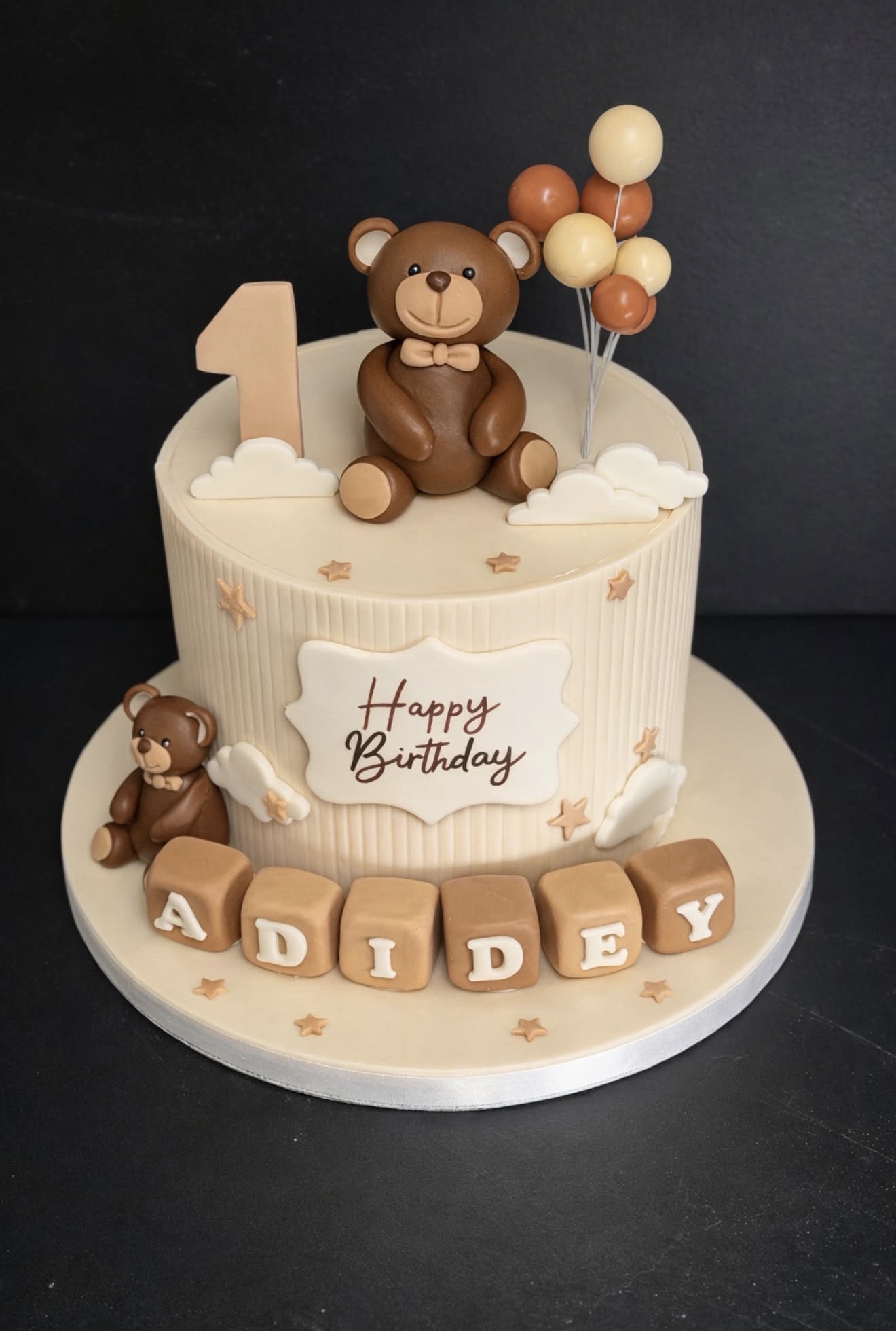 Teddy bear first birthday cake with name blocks