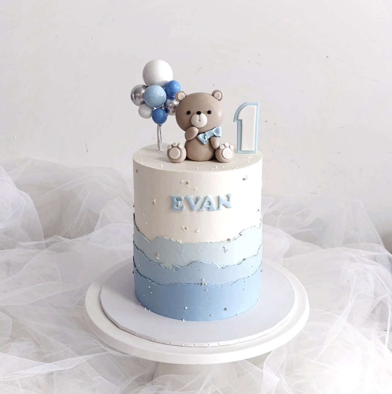 Blue teddy bear first birthday cake